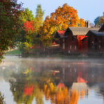 Red ochre riverside warehouses in fall
