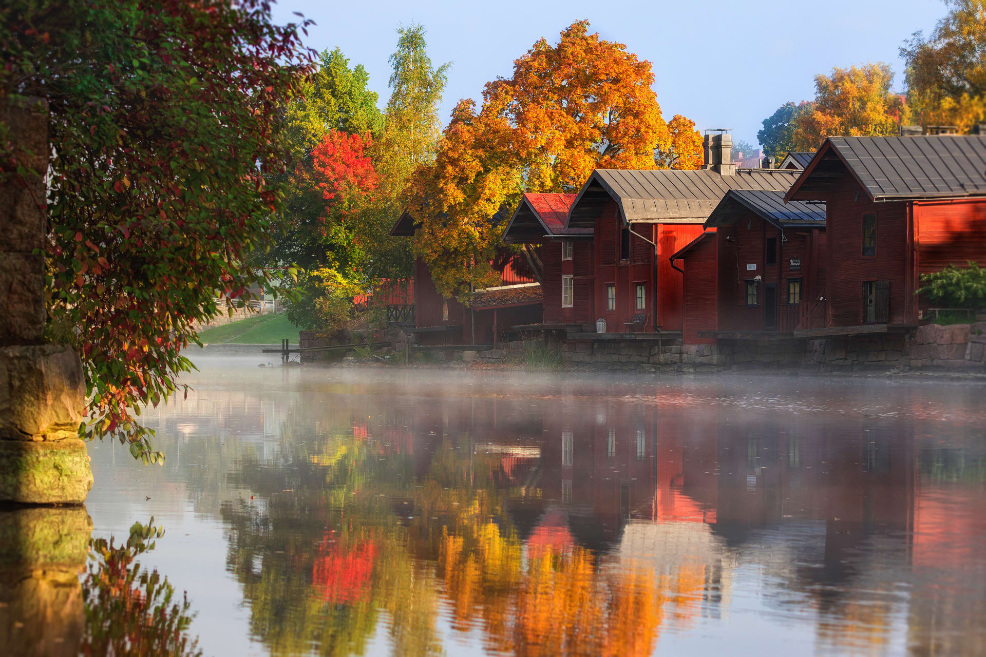 Red ochre riverside warehouses in fall