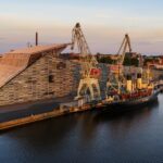 Maritime Centre Vellamo building and Icebreaker Tarmo captured from the sea in summer sunset light.