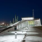 Frosty winter night with snow on the ground, Vellamo with lights shining.