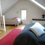 A mezzanine with beds. Th cottage accommodates 7 people in total