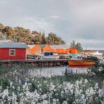 Here, the old harbor bay is lined with red beach storehouses and boathouses.