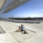 Man and child taking a photo on the roof top of Vellamo.