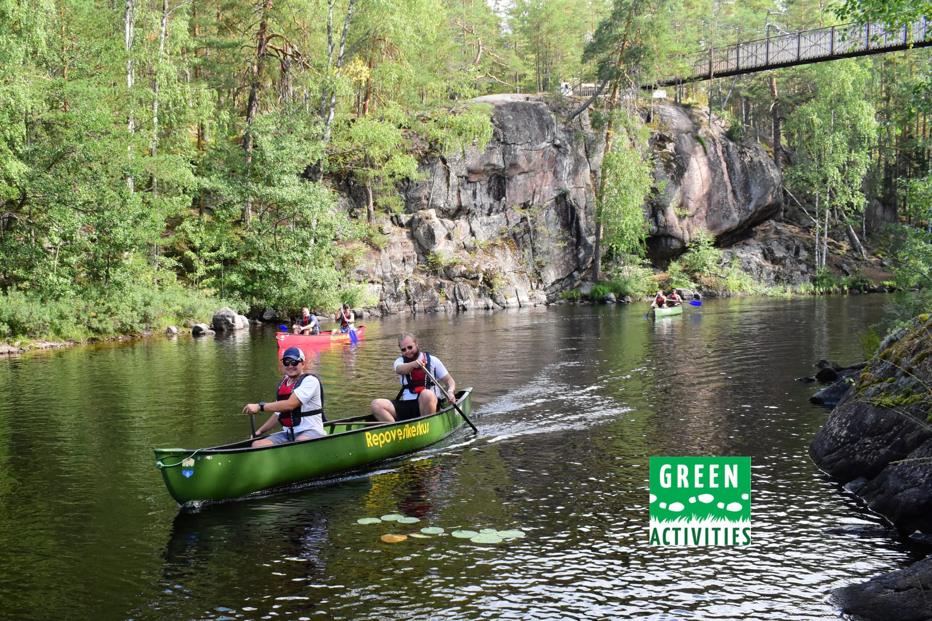 Canoeing under the suspension bridge in Repovesi National Park