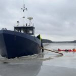 Ice breaking steel boat driven into the ice in the archipelago.